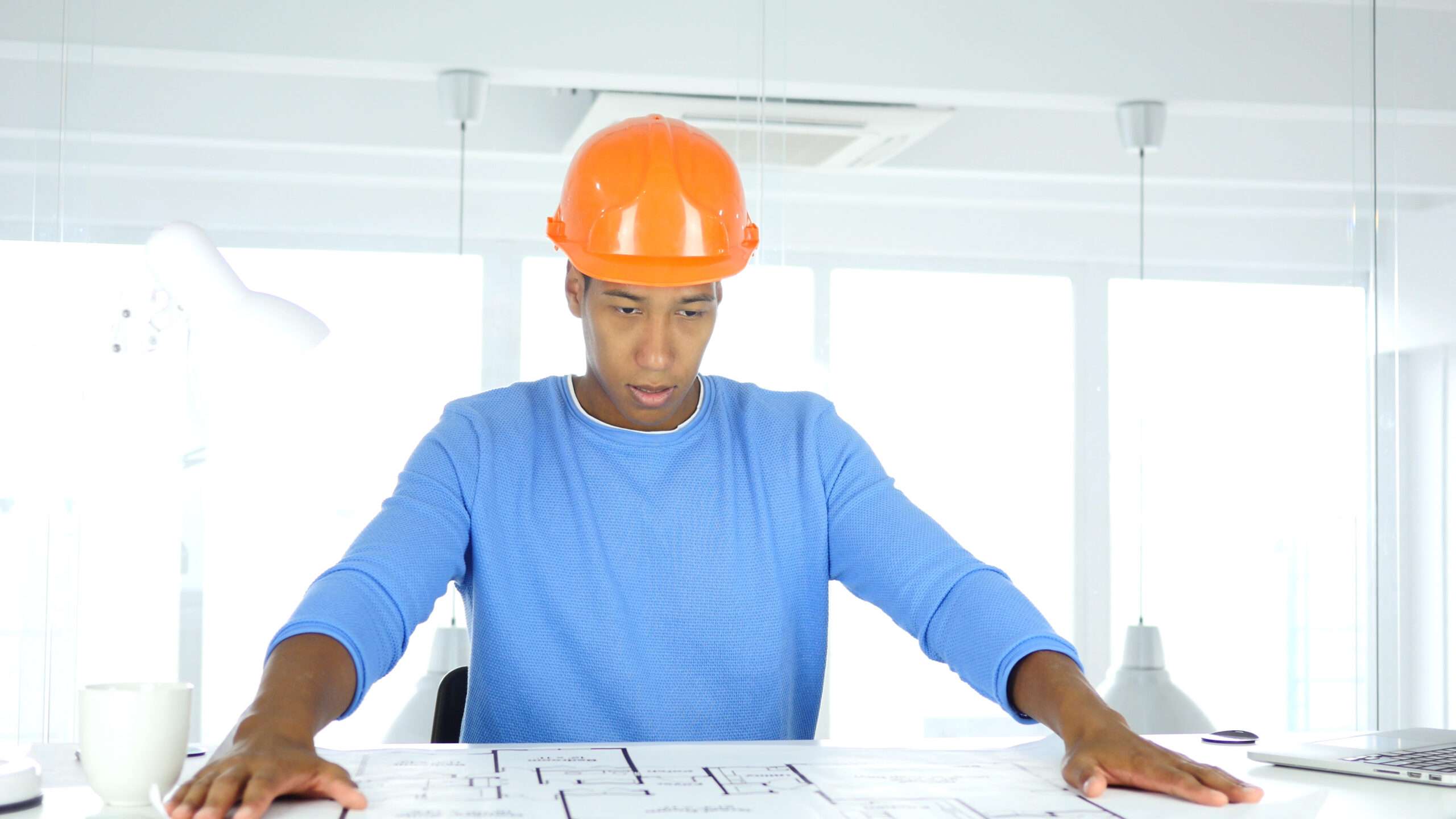 Young adult in construction training reviewing blueprints as part of workforce development program